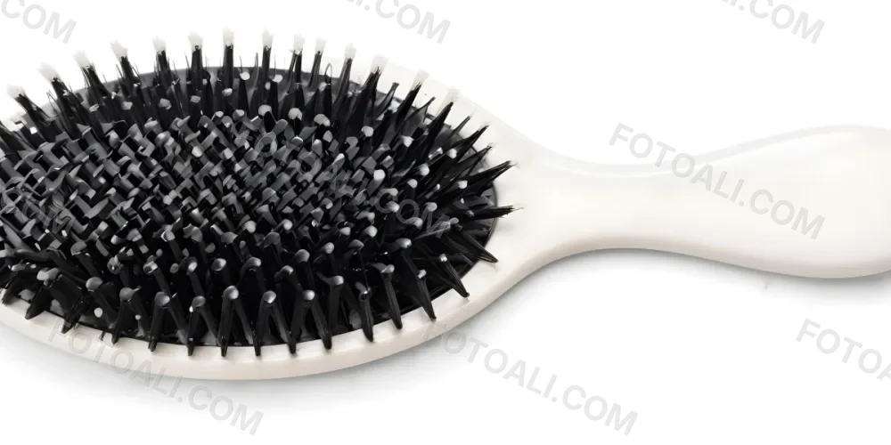 A Black Hair Brush With White Bristles Placed On A Marble Countertop 1 E42f