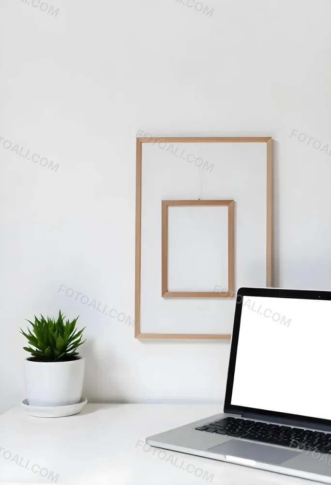 A Black Picture Frame On A White Wall With A Small Potted Plant In The Foreground 6 0634