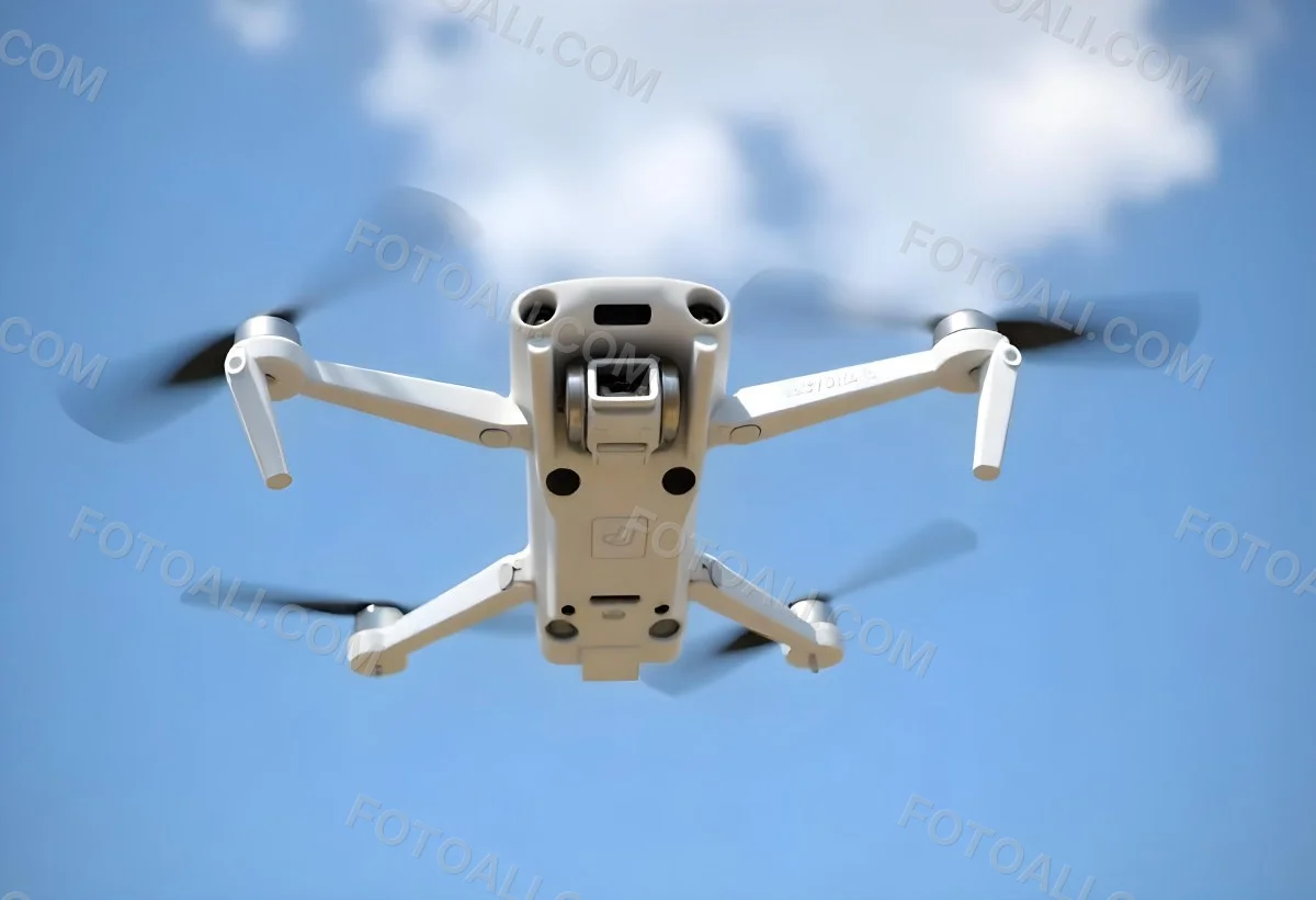 A Blue Dji Mini 3 Pro Drone With Blue Propellers In Mid Air Against A Bright Blue Sky With Scattered White Clouds 23 44ad