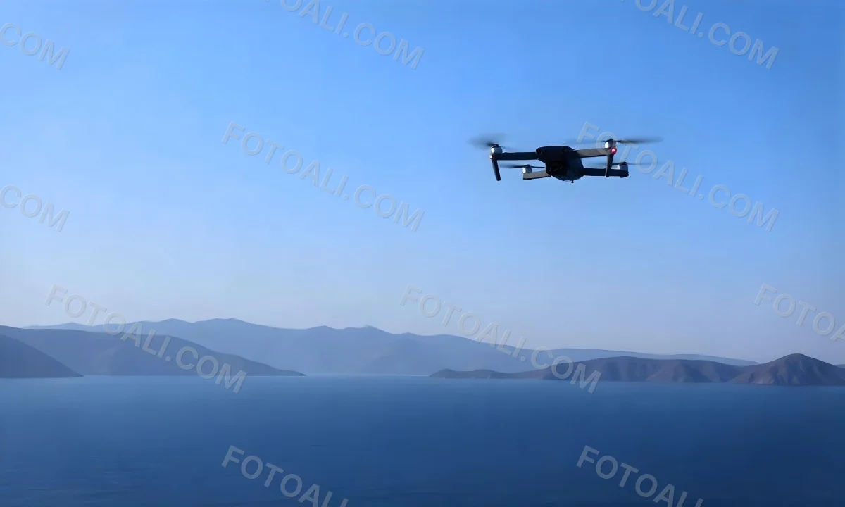 A Blue Drone Flying Over The Mountains With Mountains In The Background And A Clear Blue Sky 19 F013