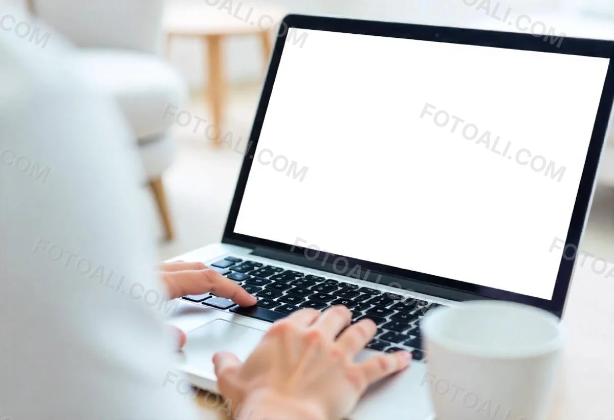 A Brown Skin Hand Holding A Blue Credit Card Over A Laptop The Background Is Blurred And Looks Like An Office 19 F79a