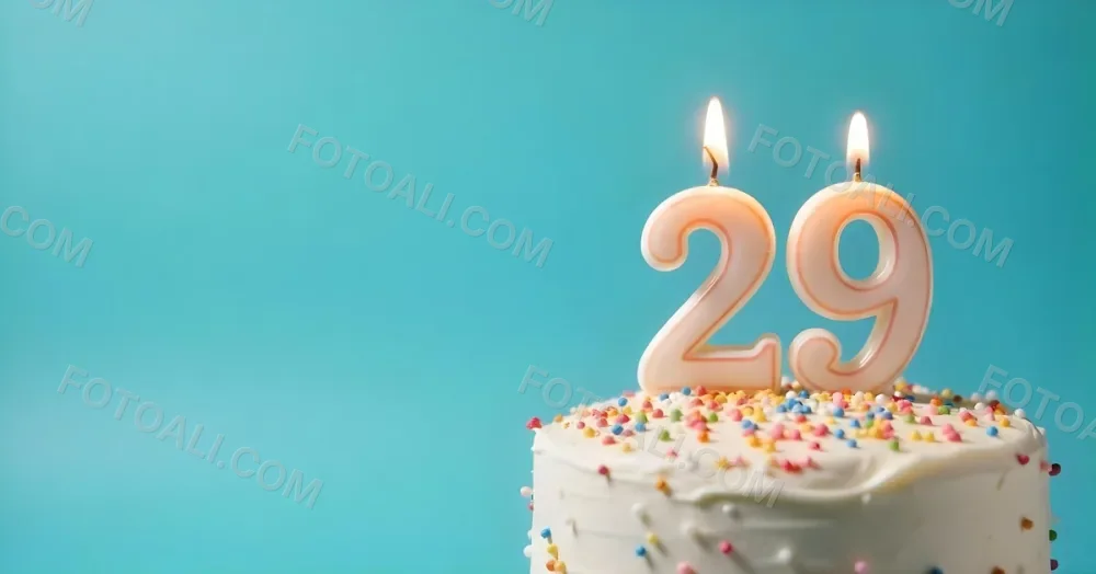 A Cake With White Frosting And Colorful Sprinkles Topped With A Candle In The Shape Of The Number 29 Blue Background 27 02aa