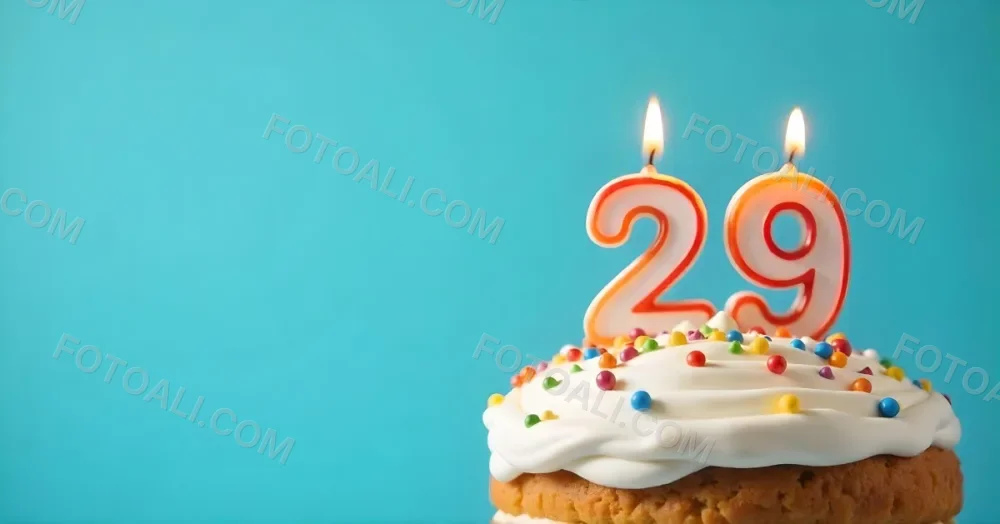 A Cake With White Frosting And Colorful Sprinkles Topped With A Candle In The Shape Of The Number 29 Blue Background 33 D551