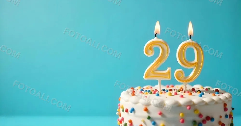 A Cake With White Frosting And Colorful Sprinkles Topped With A Candle In The Shape Of The Number 29 Blue Background 7 Dfe3