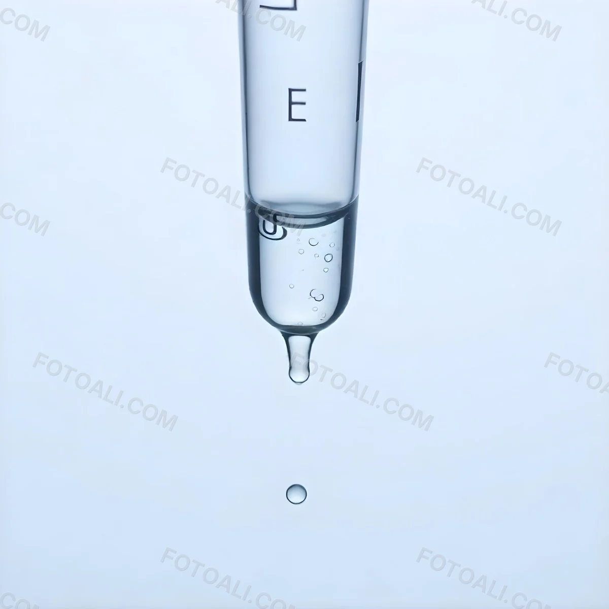 A Close Up Of A Glass Pipette With Water Droplets Against A Blue Background 2 2433