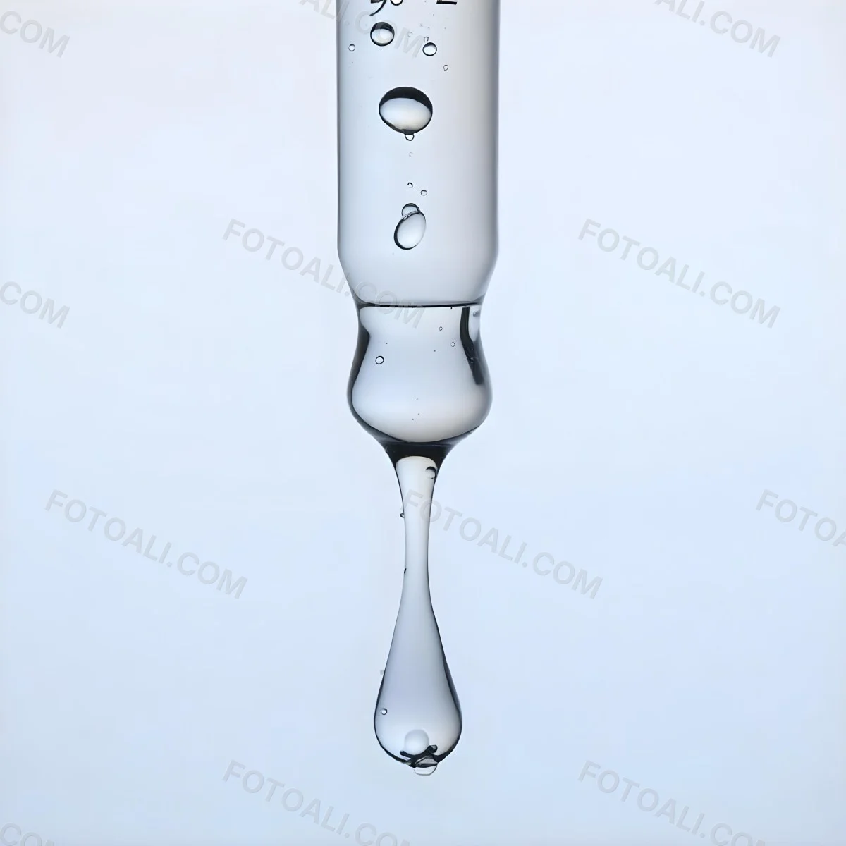 A Close Up Of A Glass Pipette With Water Droplets Against A Blue Background 6 F2fa