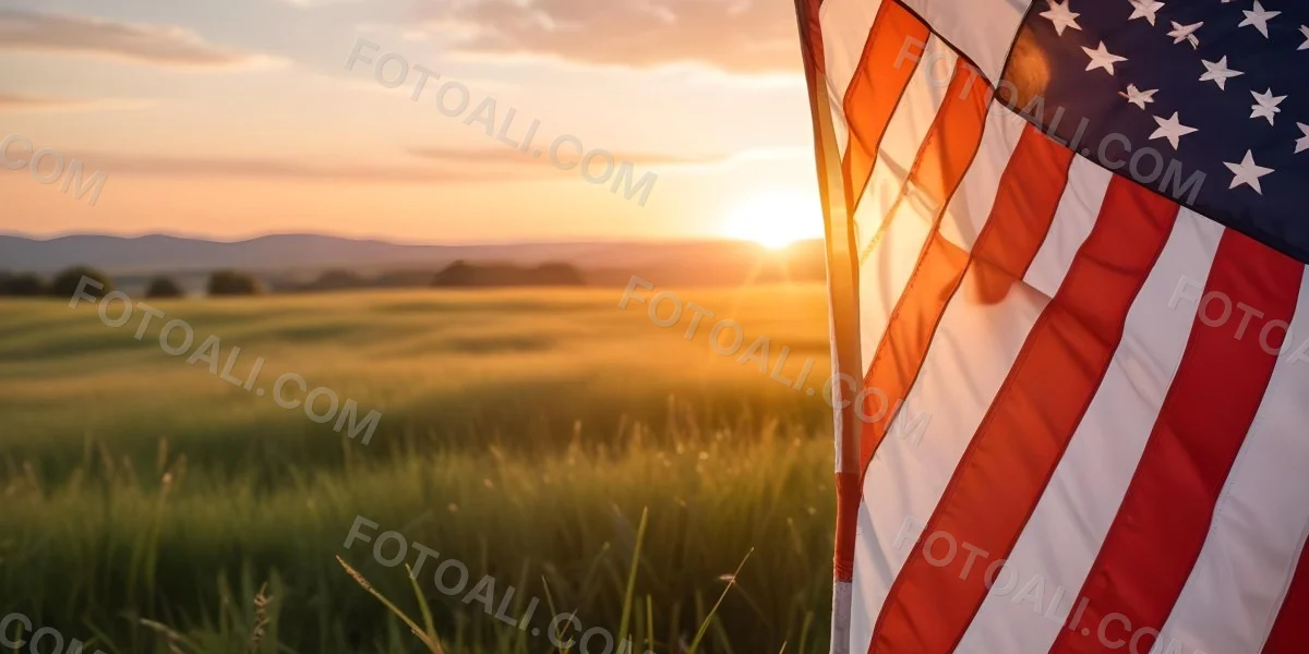 A Close Up View Of An American Flag Against A Scenic Sunset Landscape With A Grassy Field And A Bright Orange Sky 22 E345