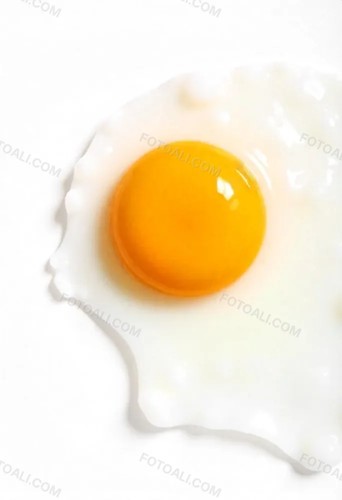 A Fried Egg With A Bright Yellow Yolk And Translucent White On A White Surface Top Down View Studio Lighting Food Photography 33 01cb
