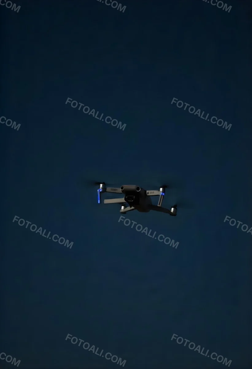 A Gray Mavic 2 Drone With Blue Propellers In The Air The Sky Is Black 8 9bd3