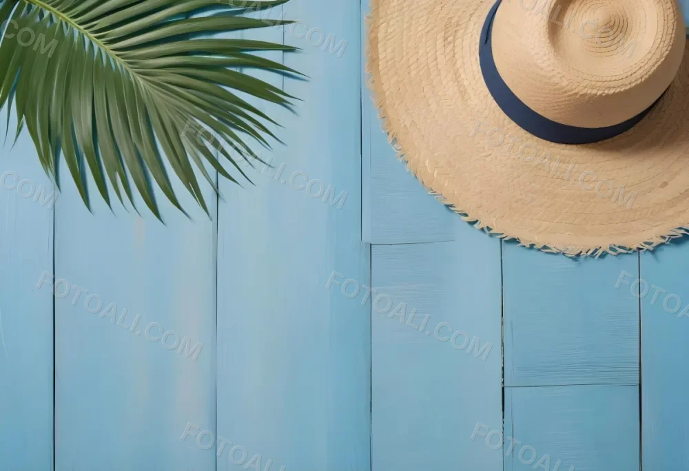 A Straw Hat And A Palm Leaf On A Blue Wooden Surface With Sand Creating A Summery And Beachy Vibe Top View 6 2ec4