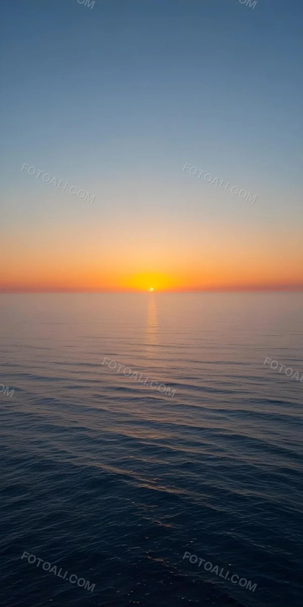 A Sunset Over The Ocean The Sky Is A Gradient Of Blue Orange And Yellow The Sun Is Setting On The Horizon 8 9841
