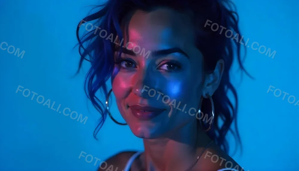 A Tanned Woman 25 Years Old With Blue Hair And Hoop Earrings Half Of Her Face Is Illuminated With Pink Light And The Other Half With Blue Light In A Blue Background 13 F140