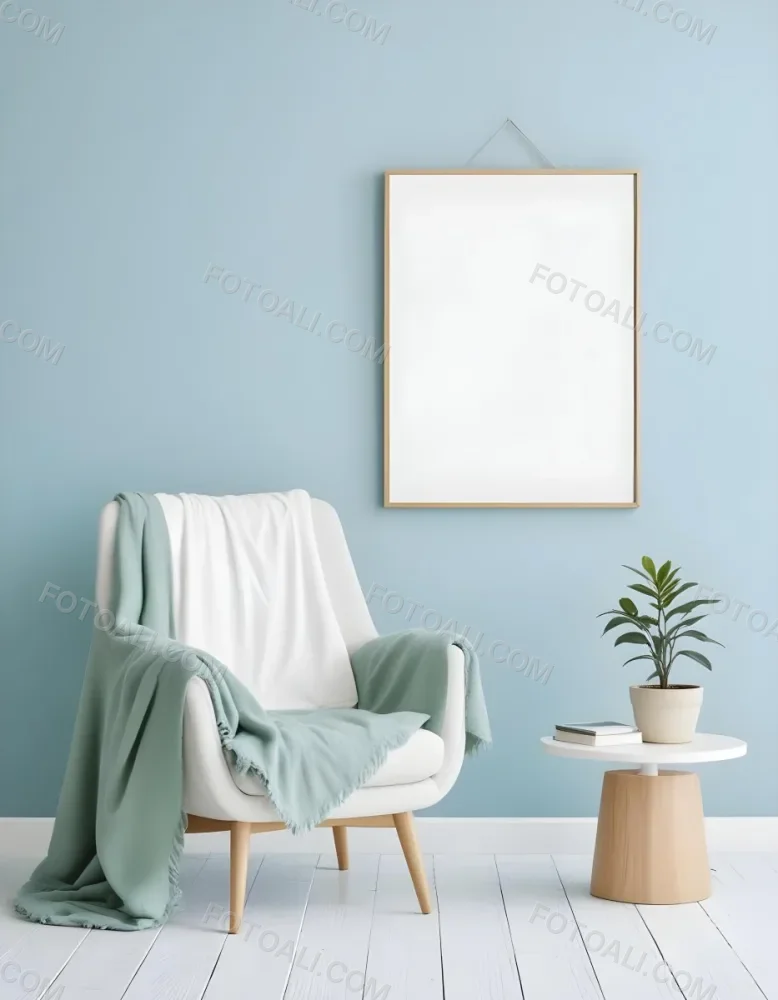 A White Armchair With A Blue Blanket Draped Over It A Small Side Table With A Potted Plant And A Blank White Frame On A Green Wall 17 10b8