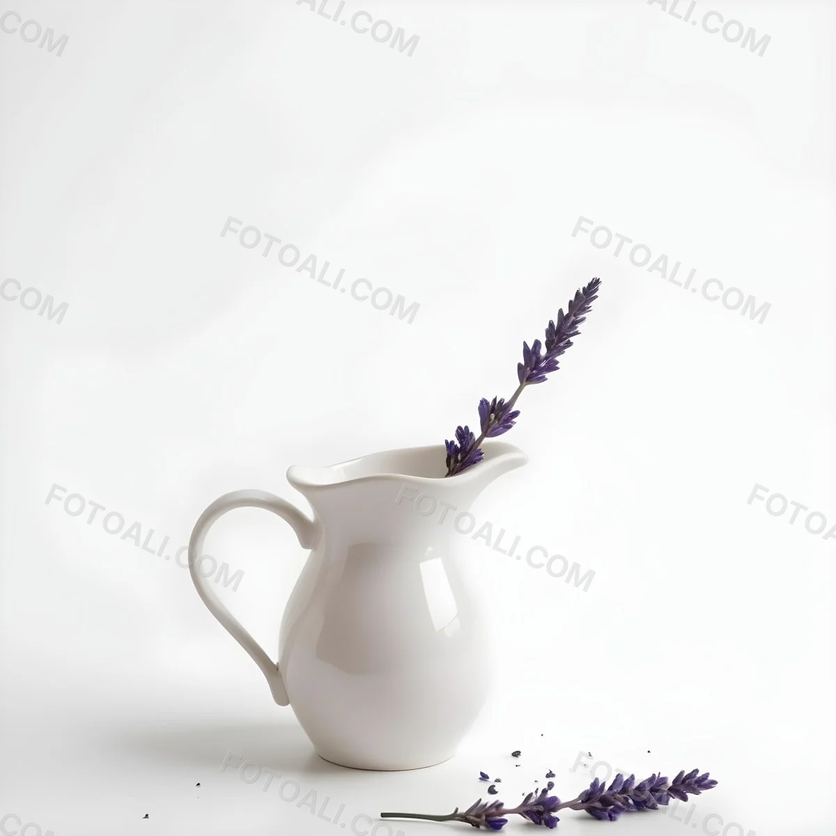 A White Ceramic Pitcher With A Sprig Of Lavender In It Another Sprig Of Lavender Is Lying On The White Surface 10 98a5