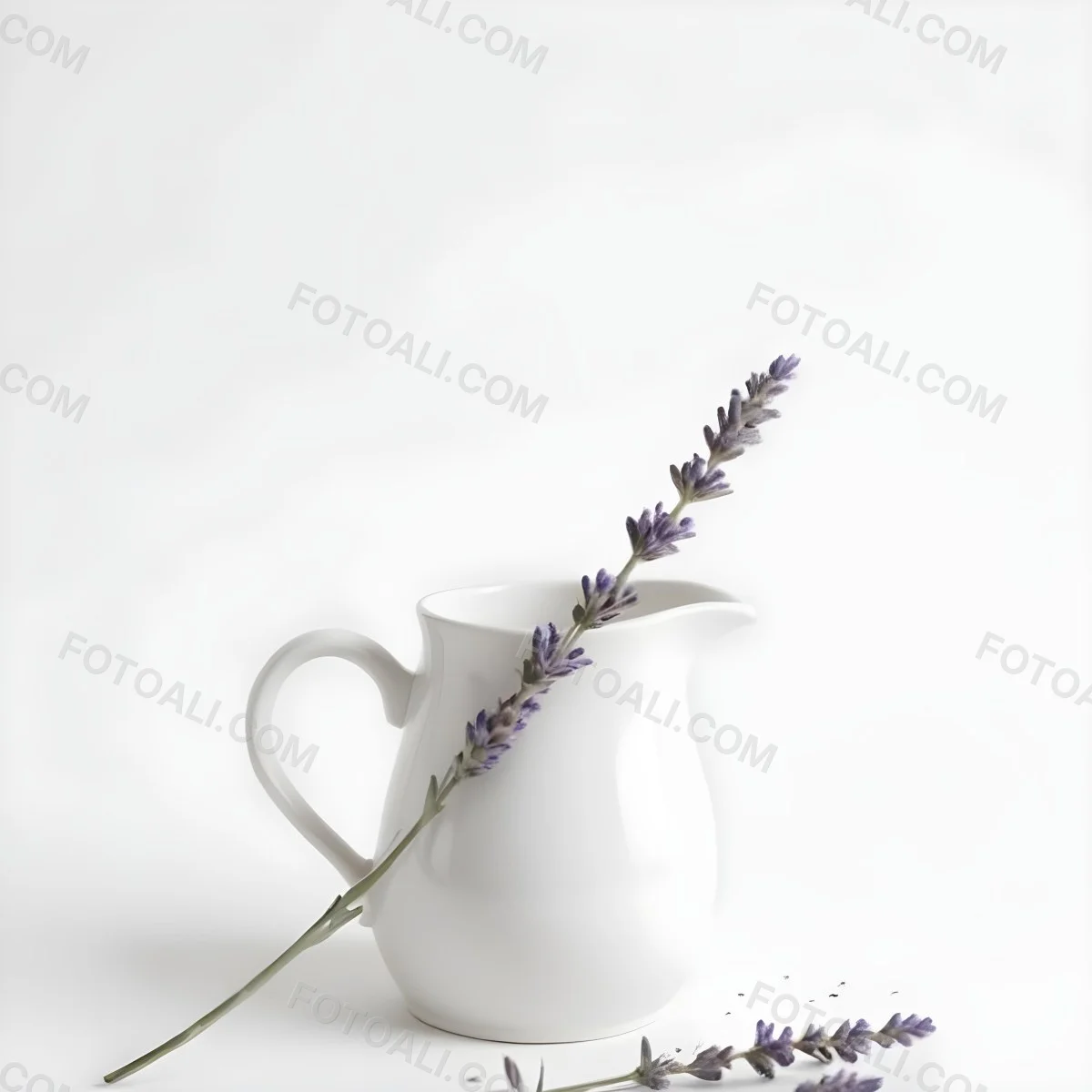 A White Ceramic Pitcher With A Sprig Of Lavender In It Another Sprig Of Lavender Is Lying On The White Surface 19 322f