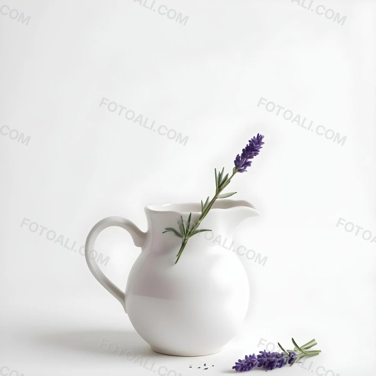 A White Ceramic Pitcher With A Sprig Of Lavender In It Another Sprig Of Lavender Is Lying On The White Surface 8 6d82