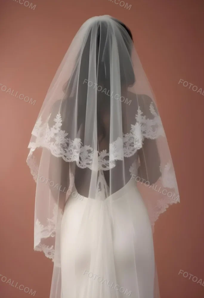 A White Wedding Dress With A Long Flowing Veil Featuring Lace Detailing 14 0490