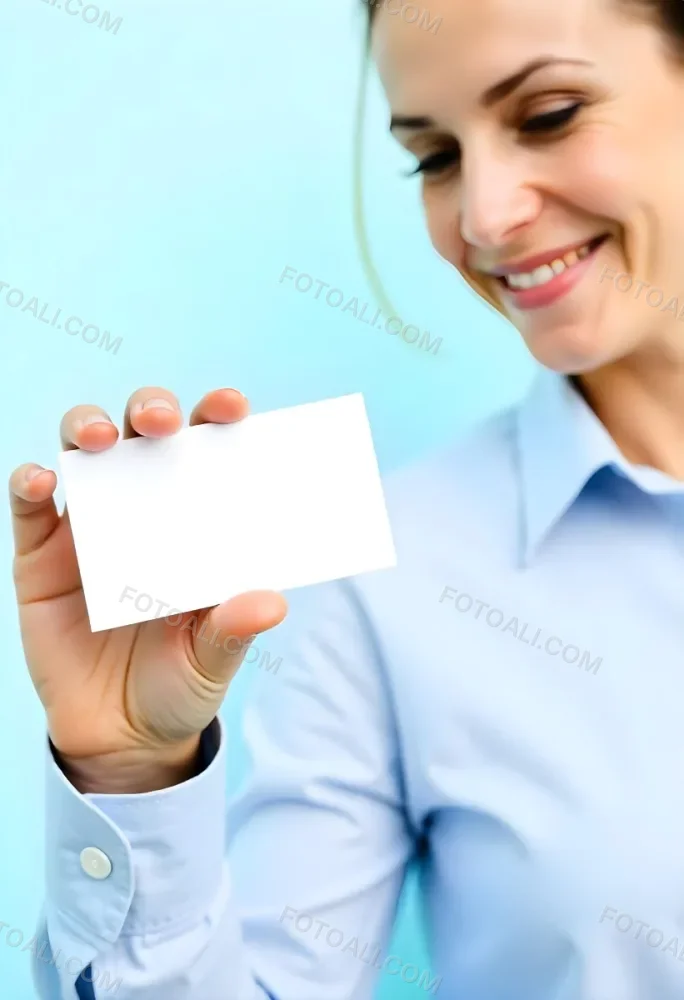 A White Woman Age 35 With A Blue Shirt Holding A Blank Business Card With A Bright Background 18 C72d