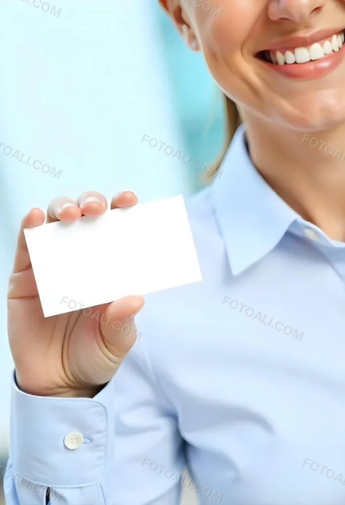 A White Woman Age 35 With A Blue Shirt Holding A Blank Business Card With A Bright Background 3 001e
