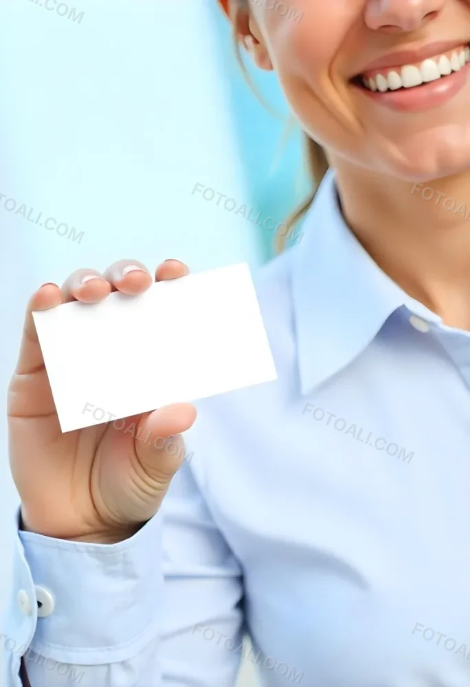 A White Woman Age 35 With A Blue Shirt Holding A Blank Business Card With A Bright Background 8 Fd54