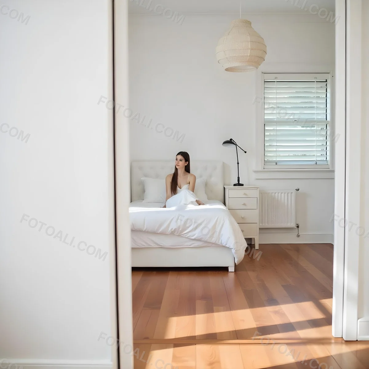 A Young Caucasian Woman With Long Brown Hair Sitting On A Bed 22 63f6