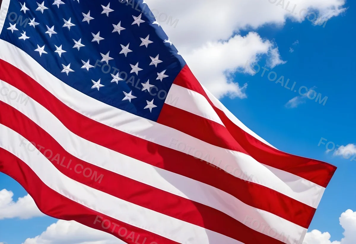 American Flag Waving In The Wind With Its Red And White Stripes And Blue Field Of Stars Against A Blue Sky With White Clouds 24 Cb41