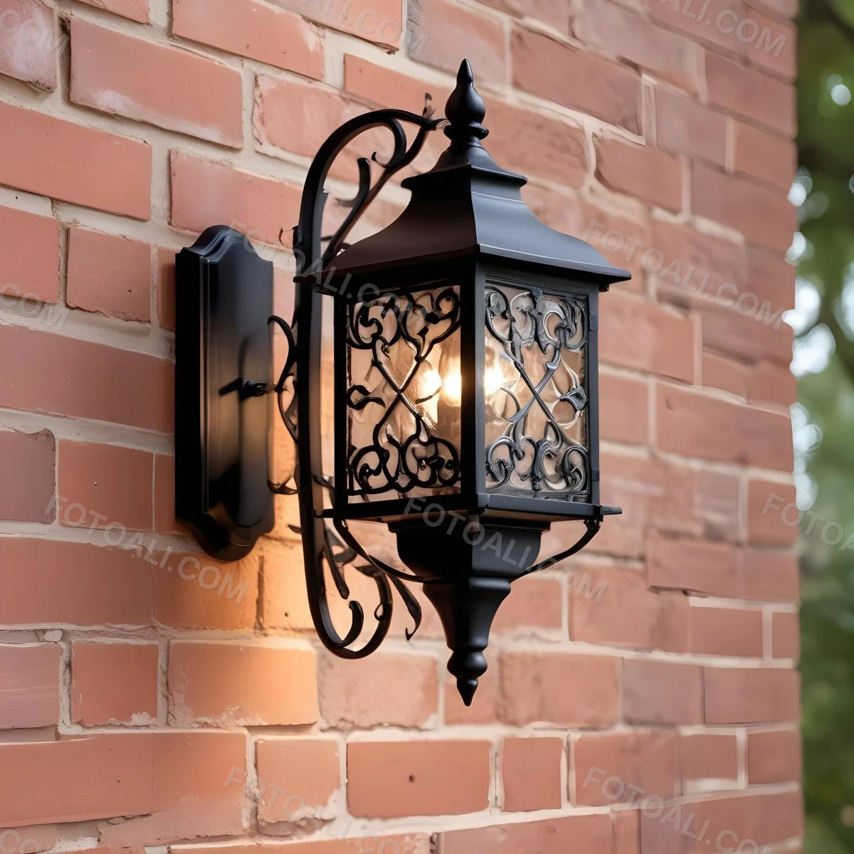 An Ornate Black Metal Outdoor Wall Sconce With A Glass Pane Design Mounted On A Brick Wall 3 0045