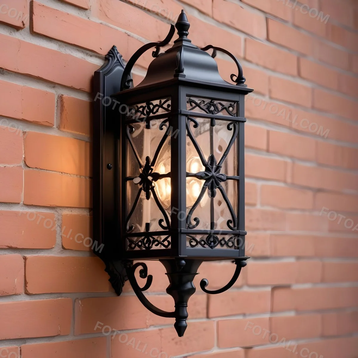 An Ornate Black Metal Outdoor Wall Sconce With A Glass Pane Design Mounted On A Brick Wall 6 44f6
