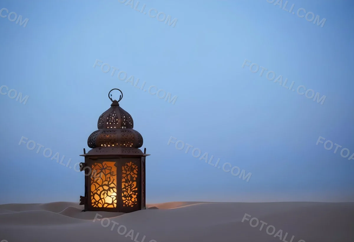 An Ornate Metal Lantern With Intricate Floral Cutouts Casting A Warm Glow On A Sandy Surface Against A Soft Gradient Blue Background 20 3a6c