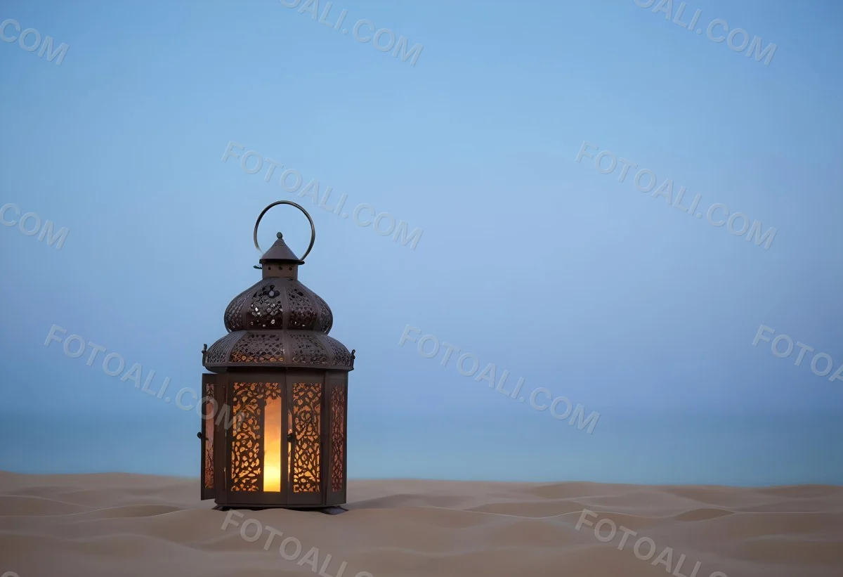 An Ornate Metal Lantern With Intricate Floral Cutouts Casting A Warm Glow On A Sandy Surface Against A Soft Gradient Blue Background 7 2288