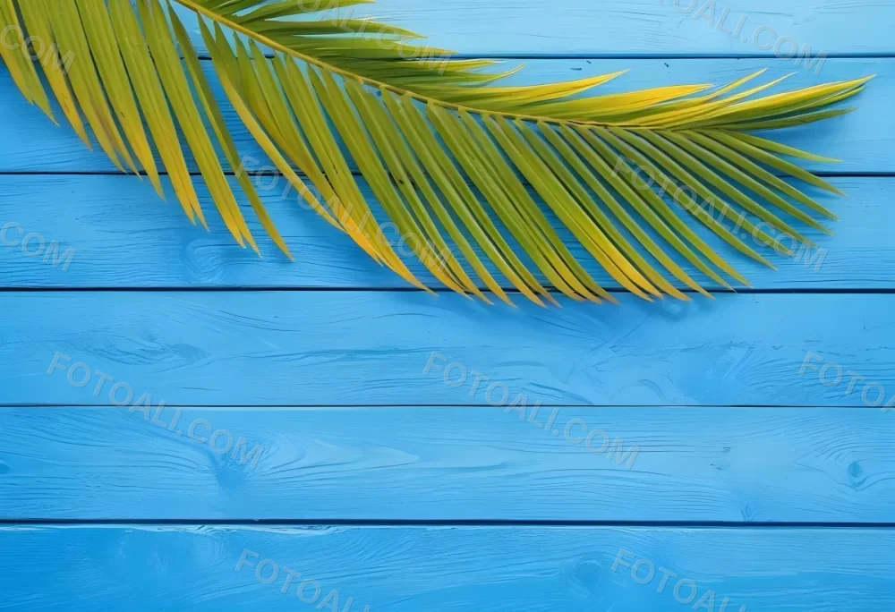Green Palm Leaf On A Blue Wooden Surface Bright Light Tropical Vibe Vibrant Colors Summer Mood Close Up Shot Clean Composition 11 17aa