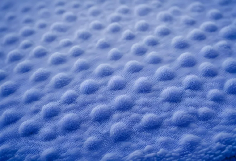 A Close Up View Of A Blue Textured Fabric Or Material With A Repeating Pattern Of Small Raised Bumps Creating A Soft Fuzzy Appearance 65 2774