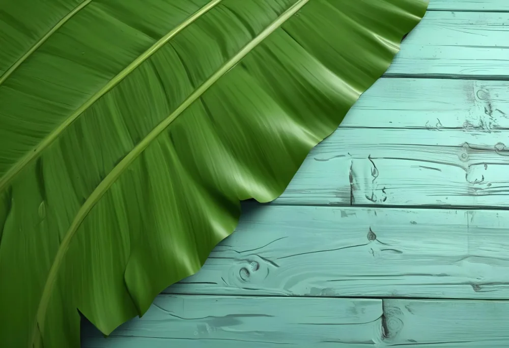 A Green Banana Leaf On A Green Wooden Surface The Leaf Is Diagonally Placed The Wooden Surface Has A Distressed Look 19 7a28