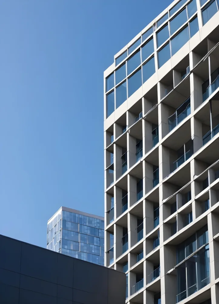 A Modern High Rise Building With A Grid Like Facade Against A Clear Blue Sky 7 Ce80