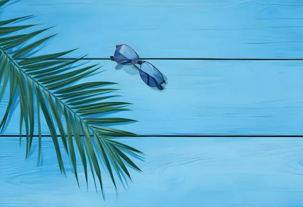 A Palm Leaf And Sunglasses On A Blue Wooden Surface Creating A Summery And Tropical Vibe Perfect For Vacation Or Beach Themed Designs 18 1f4d