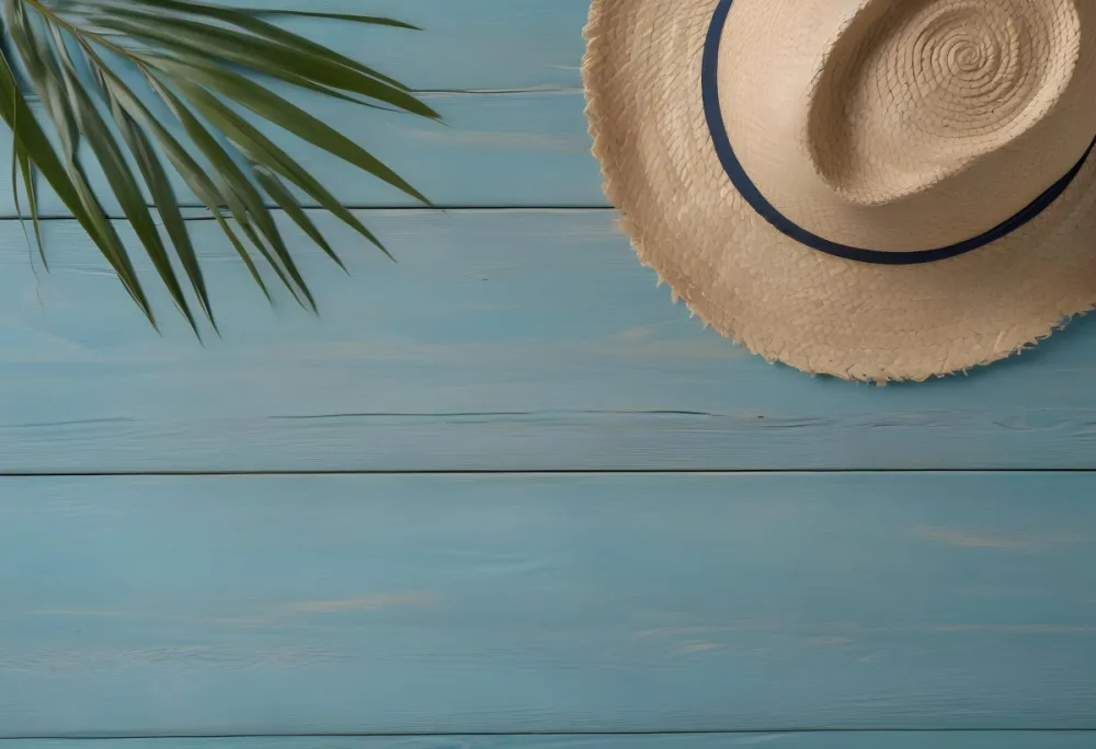 A Straw Hat And A Palm Leaf On A Blue Wooden Surface With Sand Creating A Summery And Beachy Vibe Top View 33 E30a