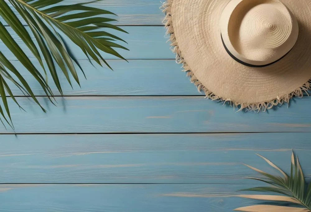 A Straw Hat And A Palm Leaf On A Blue Wooden Surface With Sand Creating A Summery And Beachy Vibe Top View 46 44c4