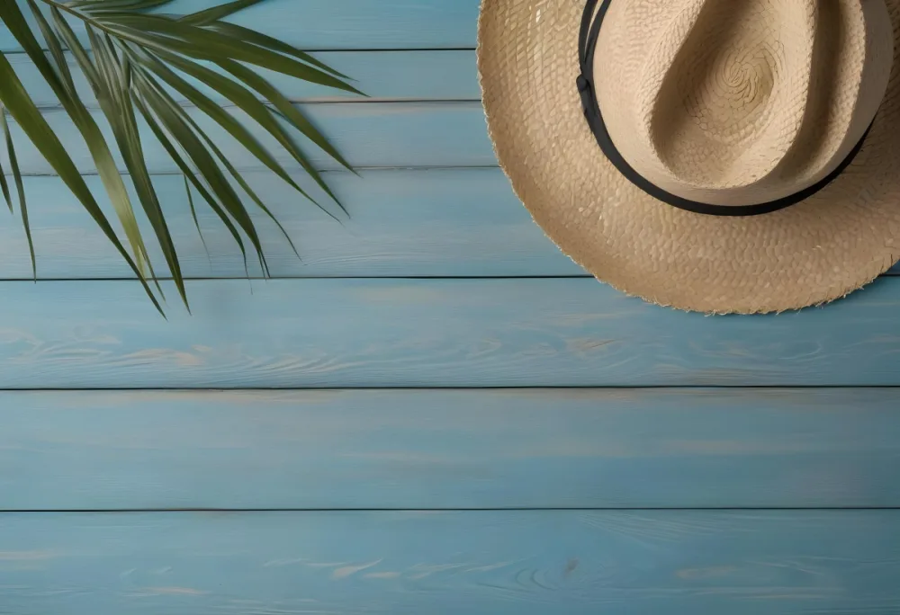 A Straw Hat And A Palm Leaf On A Blue Wooden Surface With Sand Creating A Summery And Beachy Vibe Top View 47 02fa