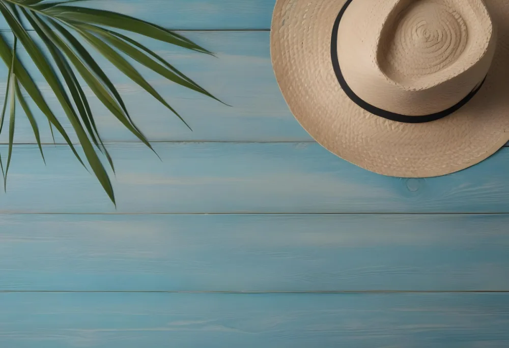 A Straw Hat And A Palm Leaf On A Blue Wooden Surface With Sand Creating A Summery And Beachy Vibe Top View 49 71d0