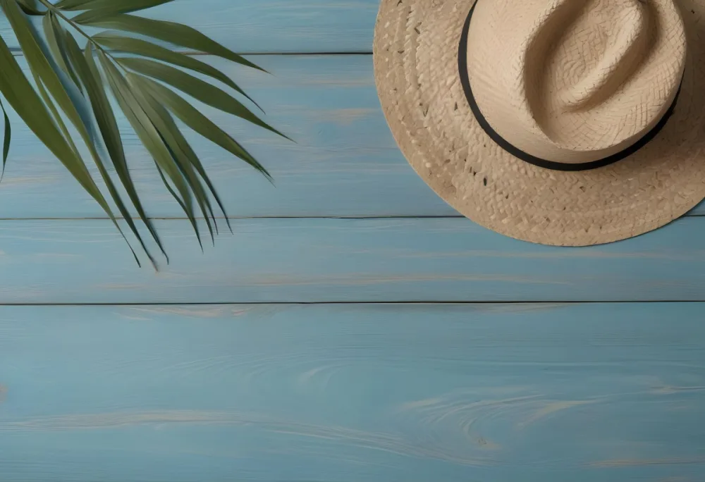 A Straw Hat And A Palm Leaf On A Blue Wooden Surface With Sand Creating A Summery And Beachy Vibe Top View 50 319d