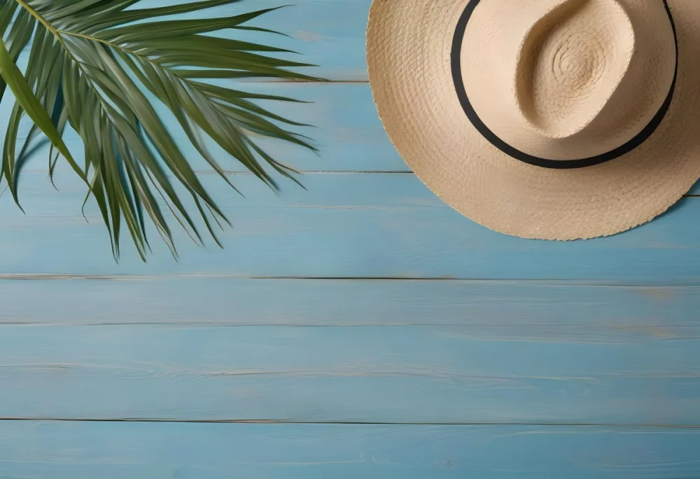 A Straw Hat And A Palm Leaf On A Blue Wooden Surface With Sand Creating A Summery And Beachy Vibe Top View 7 5f1c
