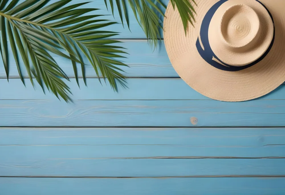 A Straw Hat And A Palm Leaf On A Blue Wooden Surface With Sand Creating A Summery And Beachy Vibe Top View 8 1385
