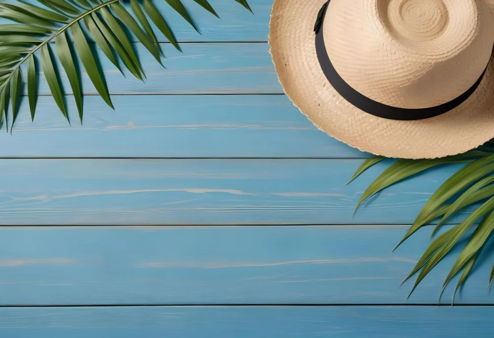 A Straw Hat And A Palm Leaf On A Blue Wooden Surface With Sand Creating A Summery And Beachy Vibe Top View 9 80b6