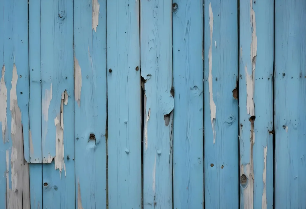 A Weathered Blue Wooden Fence With Vertical Planks Showing Signs Of Wear And Tear With The Paint Peeling Off In Some Areas 26 32b9