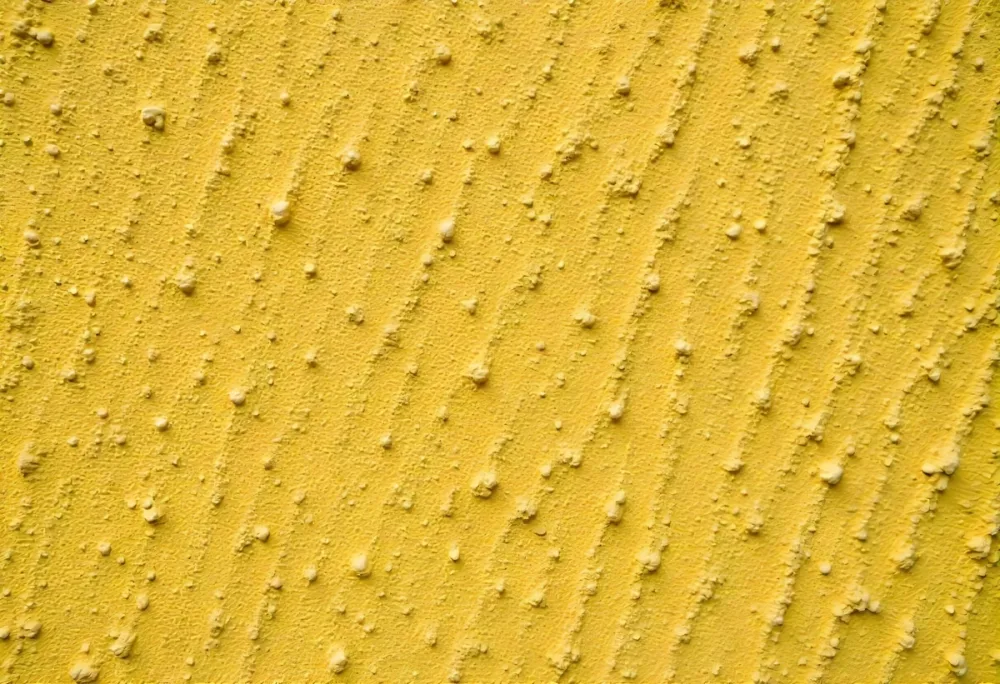 Close Up Of A Yellow Wall With A Rough Texture The Wall Is Made Of Concrete And Has A Lot Of Small Bumps 12 B4ba