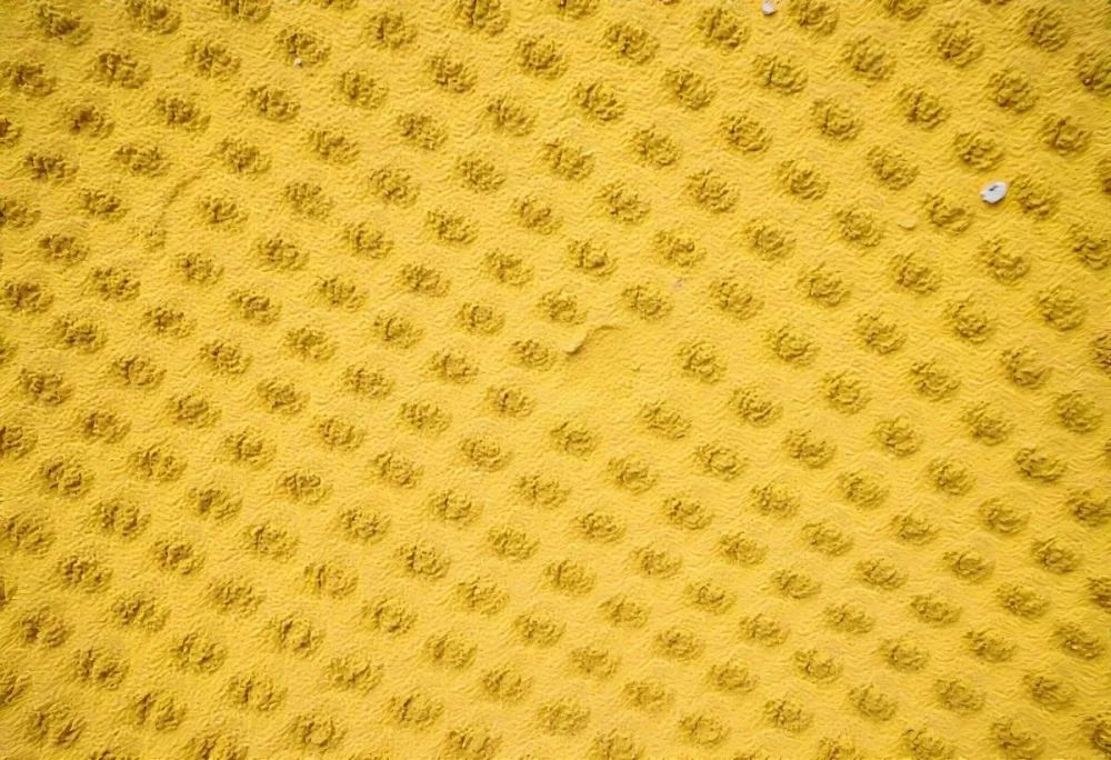 Close Up Of A Yellow Wall With A Rough Texture The Wall Is Made Of Concrete And Has A Lot Of Small Bumps 2 Ad4a