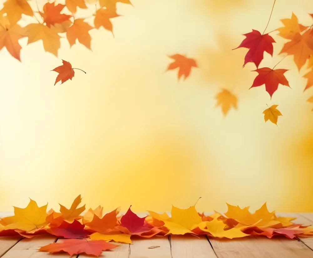 Colorful Autumn Leaves Falling On A Blurred Yellow And Orange Background With A Wooden Surface In The Foreground 24 3f82