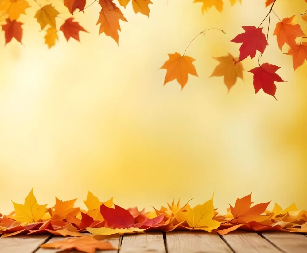 Colorful Autumn Leaves Falling On A Blurred Yellow And Orange Background With A Wooden Surface In The Foreground 25 3e5b