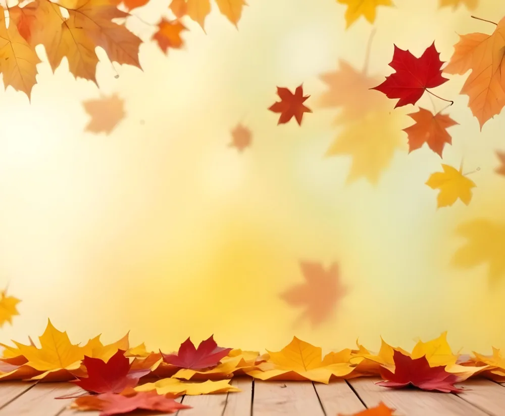 Colorful Autumn Leaves Falling On A Blurred Yellow And Orange Background With A Wooden Surface In The Foreground 26 77c7