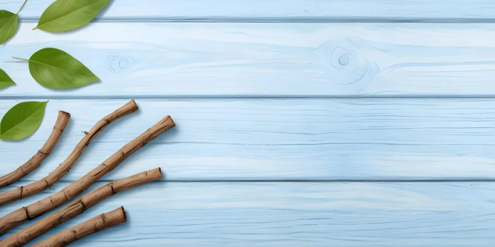 Licorice Roots Arranged In A Sun Shape On A Light Blue Wooden Surface Creating A Natural And Rustic Composition 27 D8b9